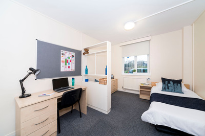 A bedroom with a single bed, desk and window in Graham.