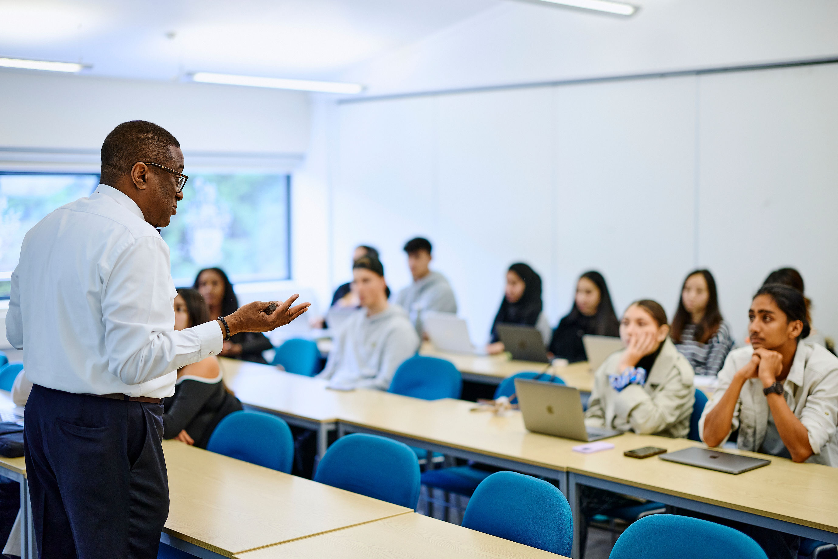 Kofi business lecturer teaching to group of students