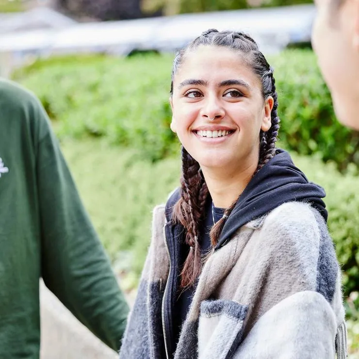 Student talking to friends outside St Mary's University London.