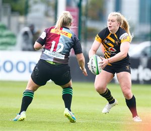 Emile Cairess and Abi Burton competing in rugby