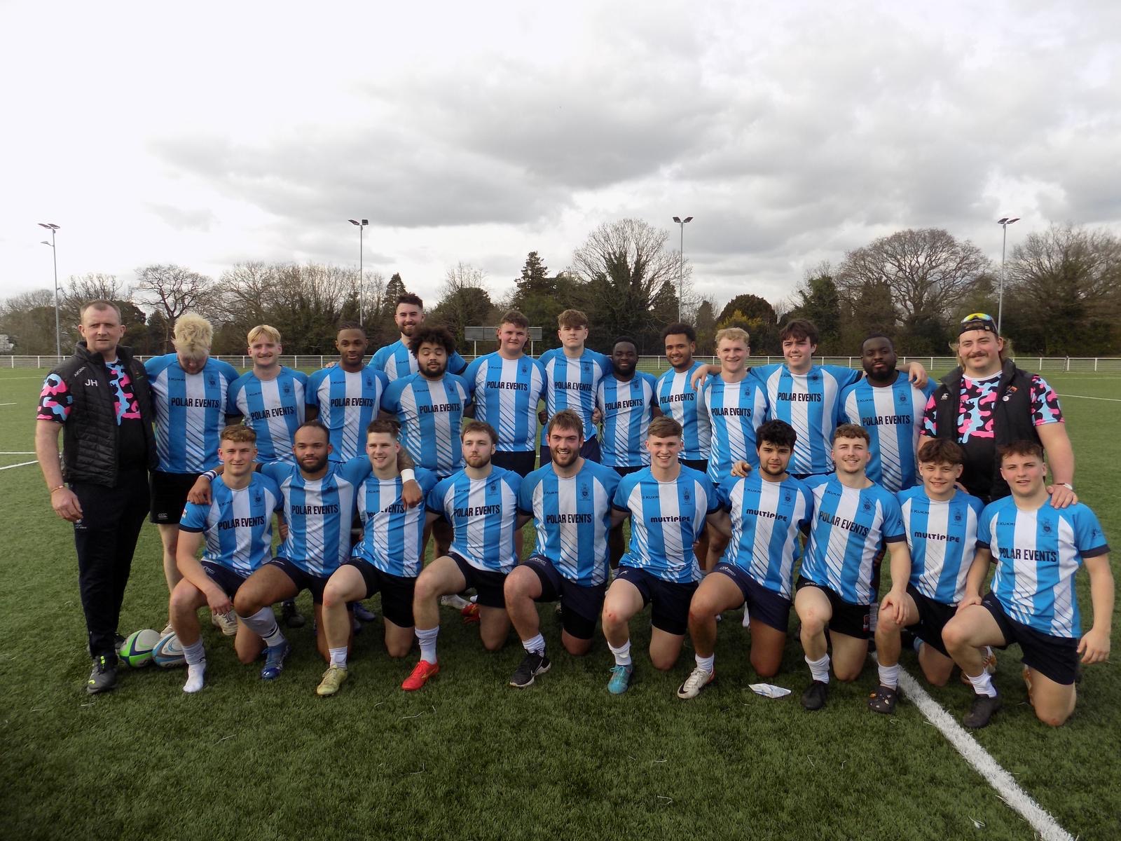 The rugby union team huddled together 