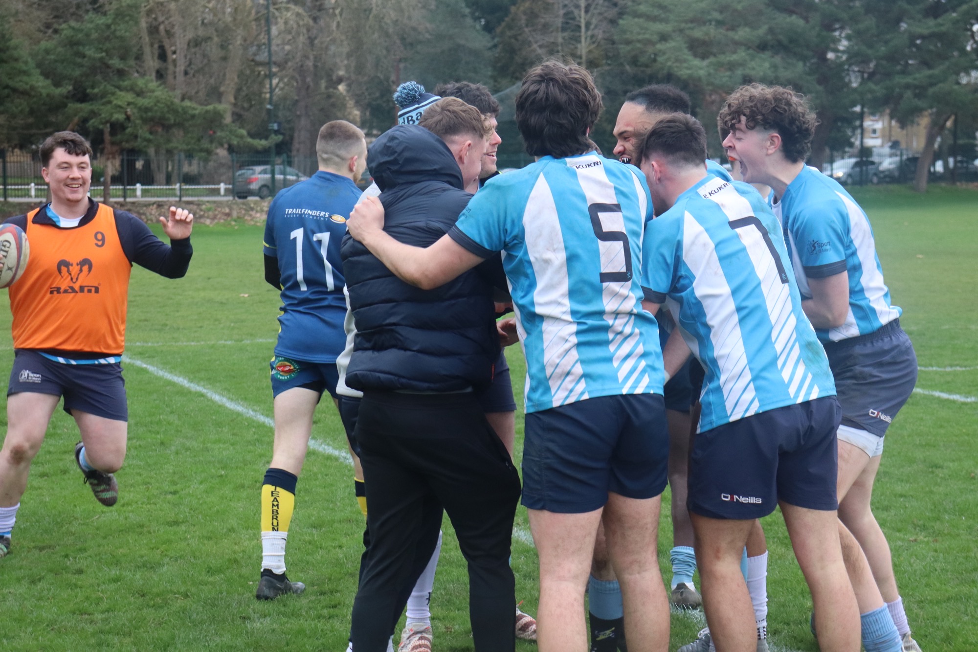 Rugby players celebrating in a huddle